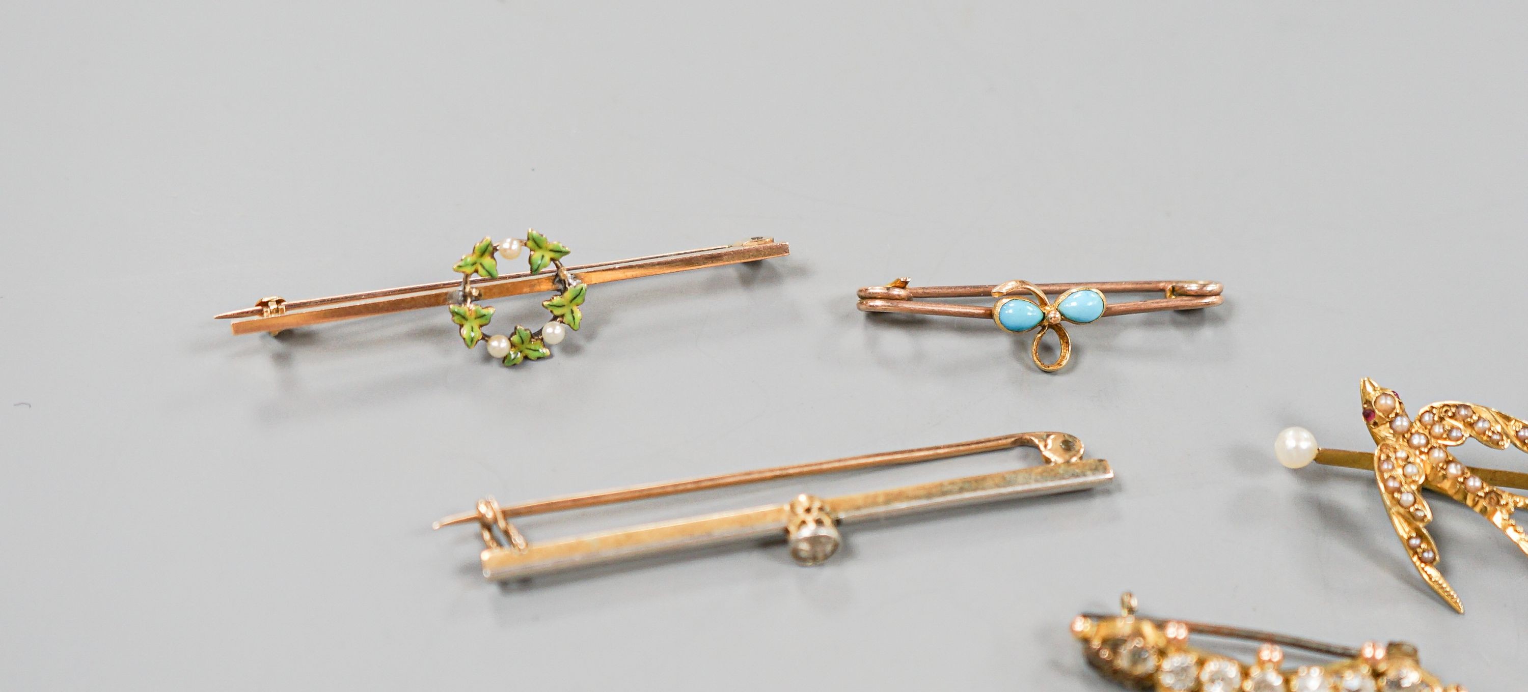 A collection of six assorted yellow metal bar brooches, including seed pearl set twin swallow, diamond set gold club and solitaire diamond set